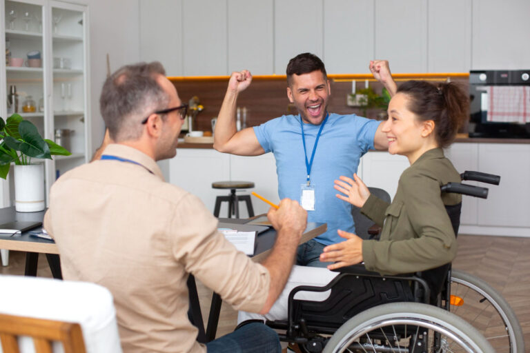 Participant and support worker talking together warmly.